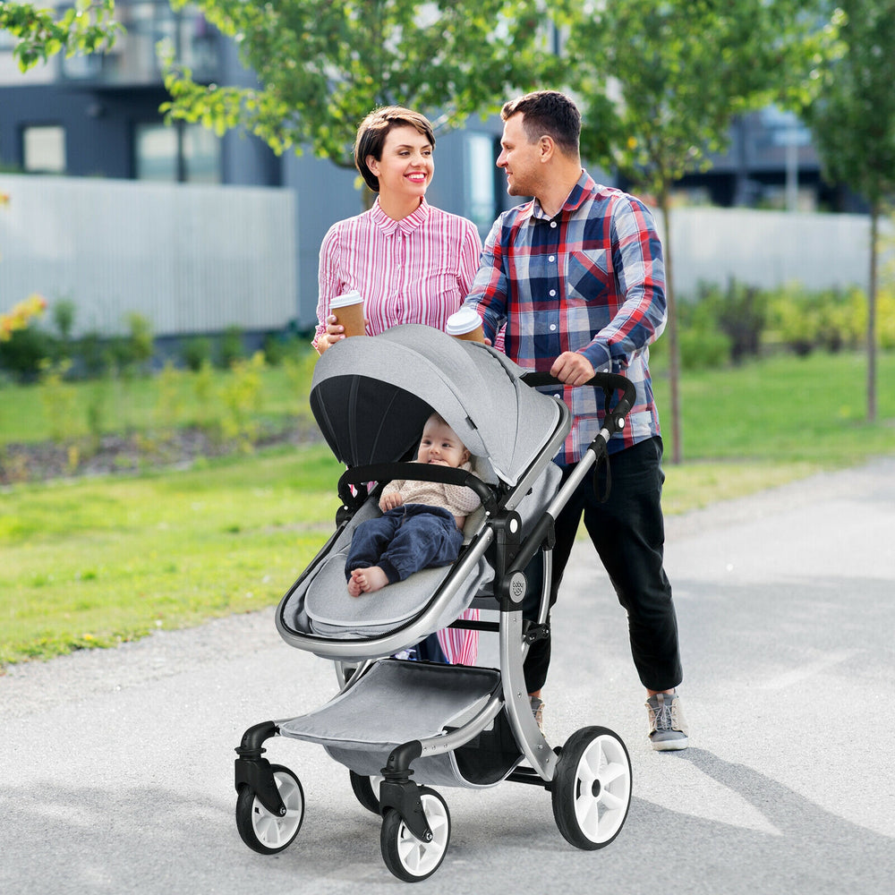 Reversible gray stroller with adjustable backrest, foot cover, and large storage basket for infants, perfect for.