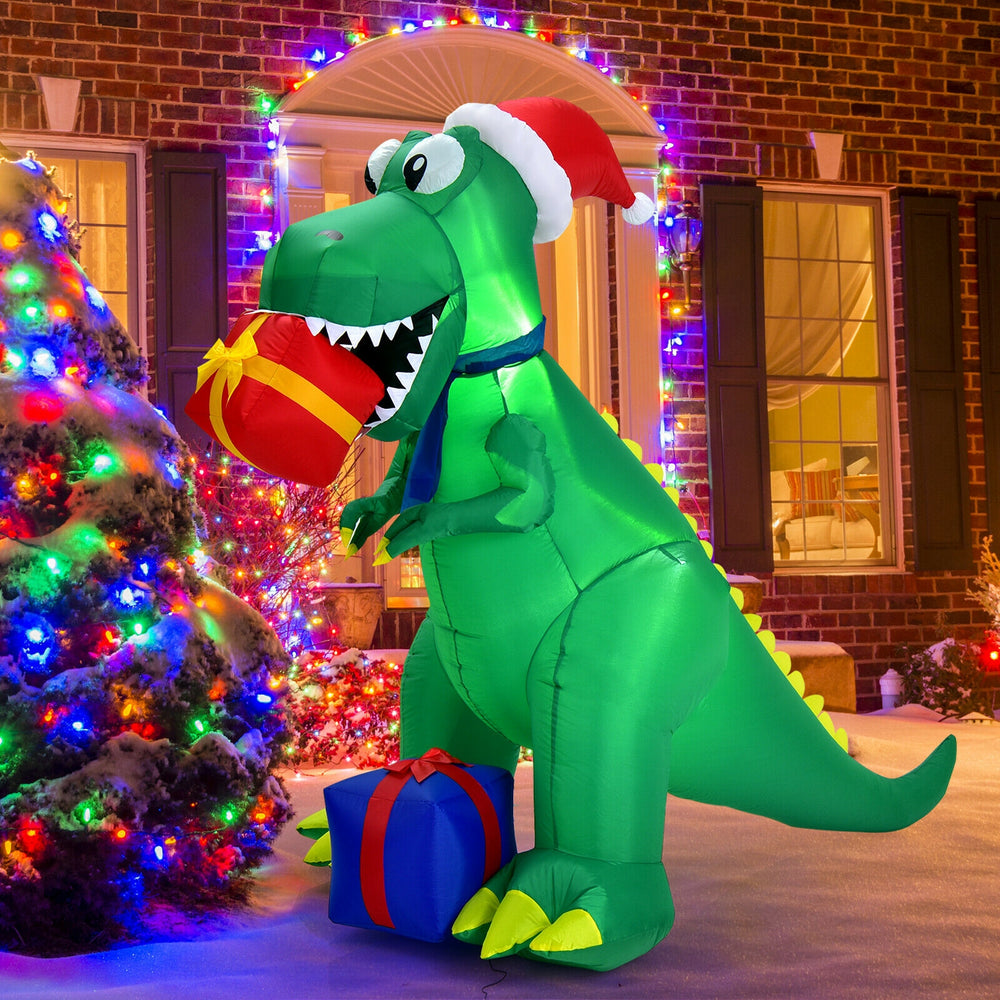 6-foot Christmas inflatable dinosaur in a snowy setting, featuring bright LED lights and a festive design for outdoor.