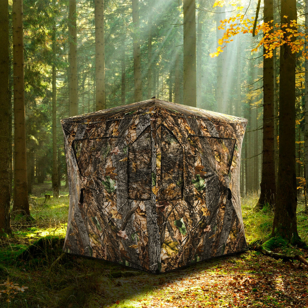 3-person portable pop-up hunting tent in camouflage, featuring gun ports and durable weather-resistant fabric for.