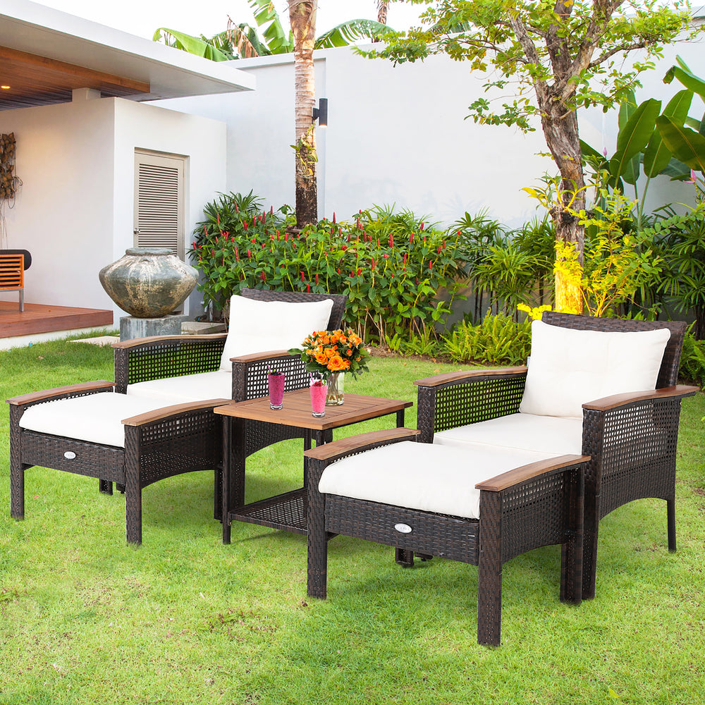 5-piece patio rattan furniture set featuring 2 chairs, 2 ottomans, and an acacia wood table for outdoor relaxation.