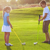 Kids practicing golf with a yellow individual club featuring a fiberglass shaft and aluminum alloy head for ages 8-10.
