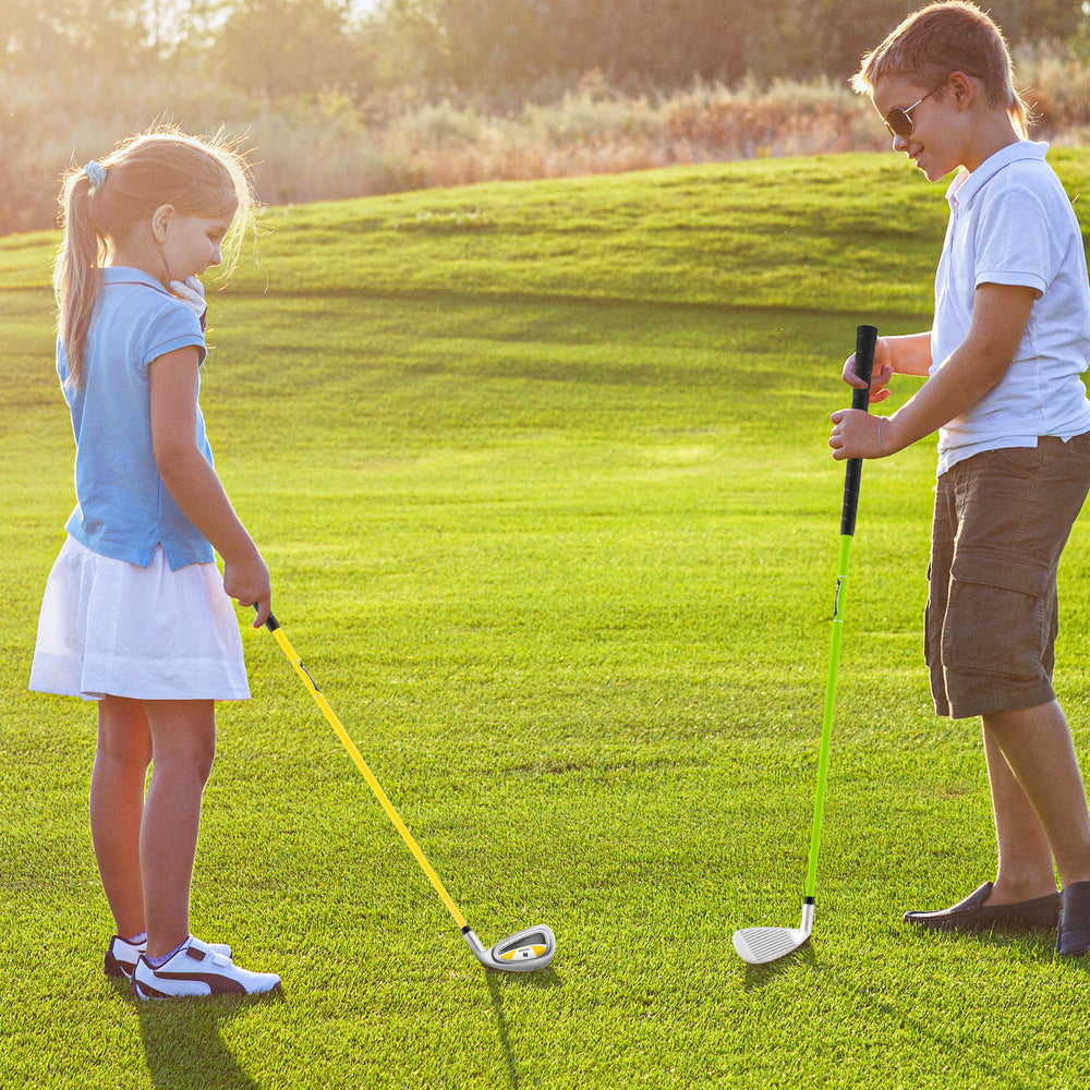 Kids practicing golf with a yellow individual club featuring a fiberglass shaft and aluminum alloy head for ages 8-10.