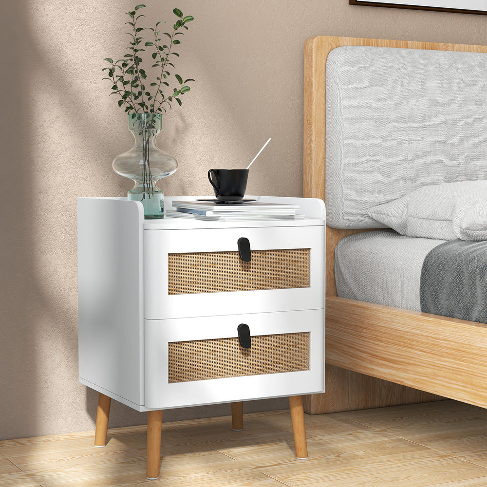 Modern bedside table with two rattan-decorated drawers and a white finish, perfect for home decor and storage.