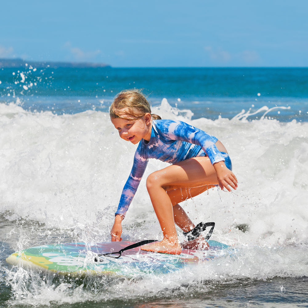 Lightweight body board with EPS core and XPE deck, perfect for kids surfing at the beach.