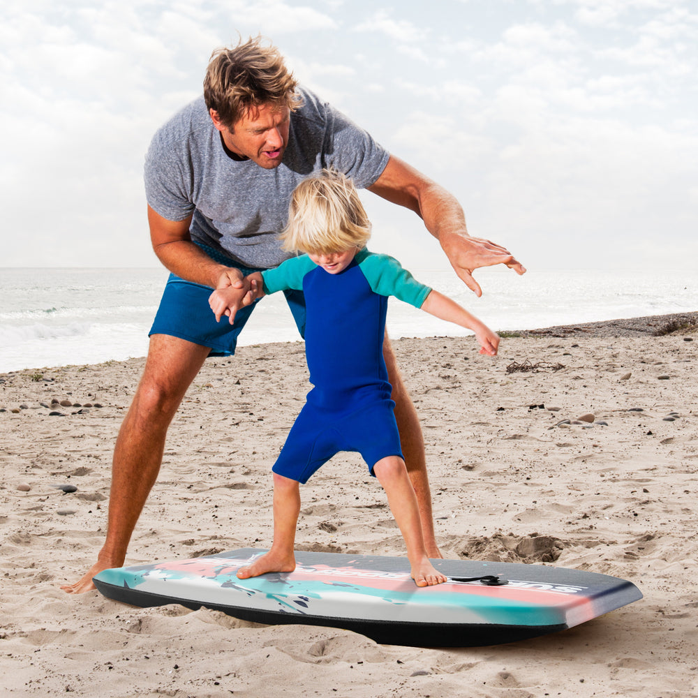 Lightweight body board with EPS core and XPE deck, used by a man and child on the beach for fun water activities.