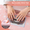 Close-up of the soft wrist pad on a pink manicure nail table with built-in dust collector and USB LED lamp.