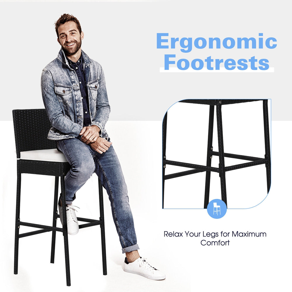 Bar stool with ergonomic footrests and soft padded cushions, featuring a sturdy steel frame and modern PE wicker design.