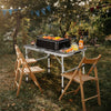 Folding aluminum grill table with iron mesh top, ideal for outdoor camping and BBQ, featuring adjustable heights and.