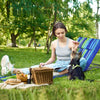 Two adjustable beach lounge chairs with a folding table, perfect for outdoor relaxation and sunbathing in summer.