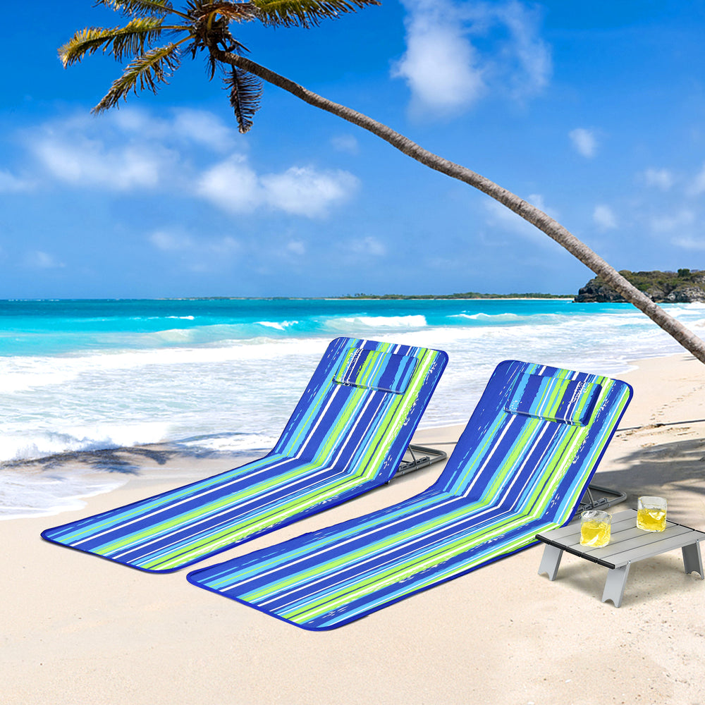 Two adjustable beach lounge chairs with a side table, featuring a colorful stripe design, perfect for outdoor.