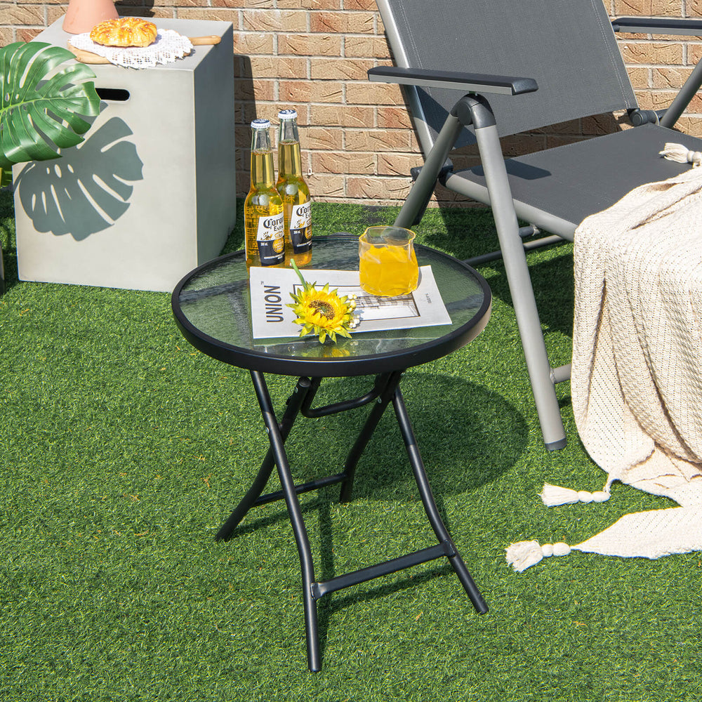 Round patio side table with tempered glass tabletop and rustproof steel frame, perfect for outdoor use and easy storage.