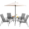 Patio dining set featuring a tempered glass tabletop, four stackable cushioned chairs, and an umbrella for outdoor use.