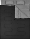 Two-person waterproof sleeping bag in black with two pillows, designed for camping and travel, featuring side zippers.