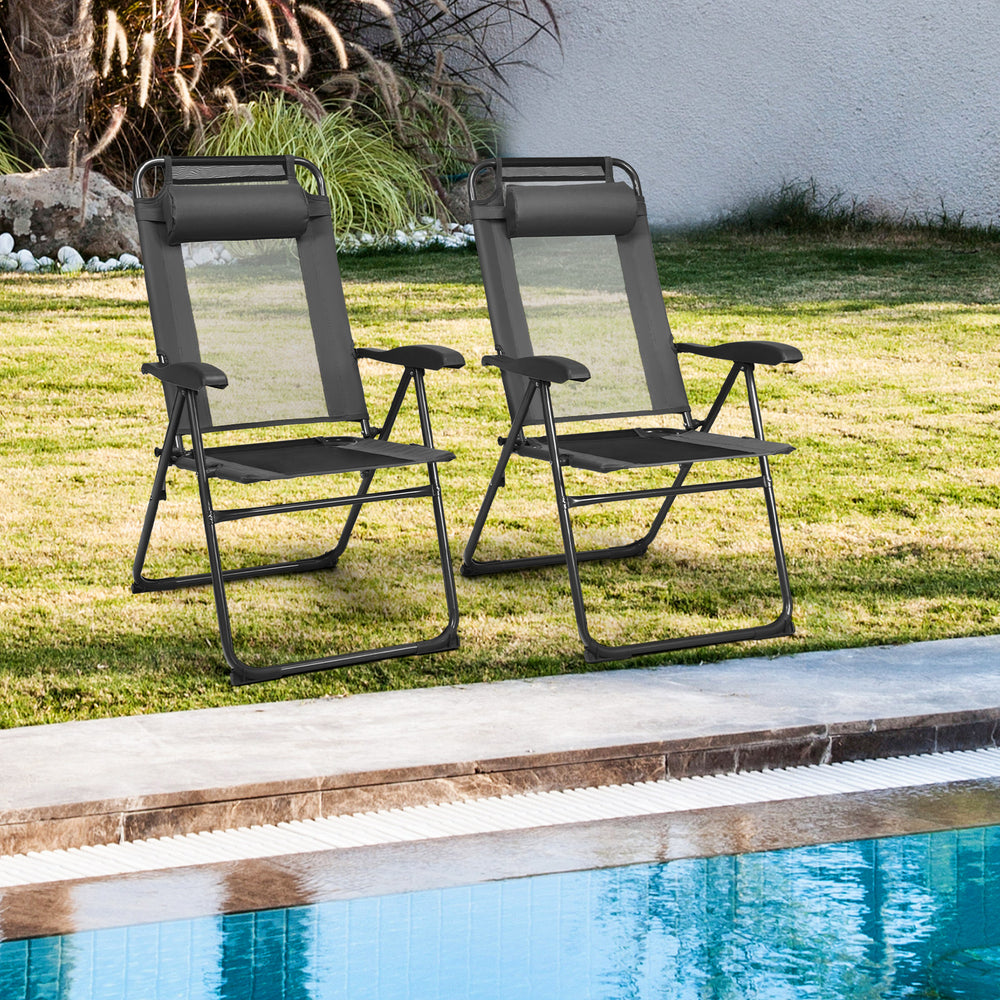 Two gray adjustable folding recliner chairs with steel frame, perfect for outdoor relaxation by the poolside.