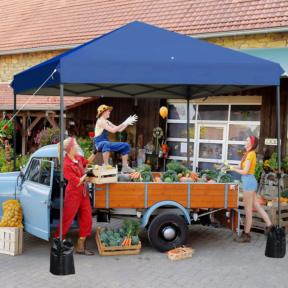 Blue 8'x8' outdoor pop-up canopy tent with sturdy steel frame, ideal for parties and camping, shown in use at a market.