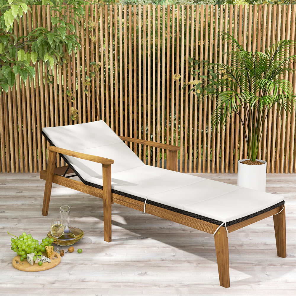 Outdoor chaise lounge chair with armrests, solid acacia wood frame, and white cushion for poolside relaxation.