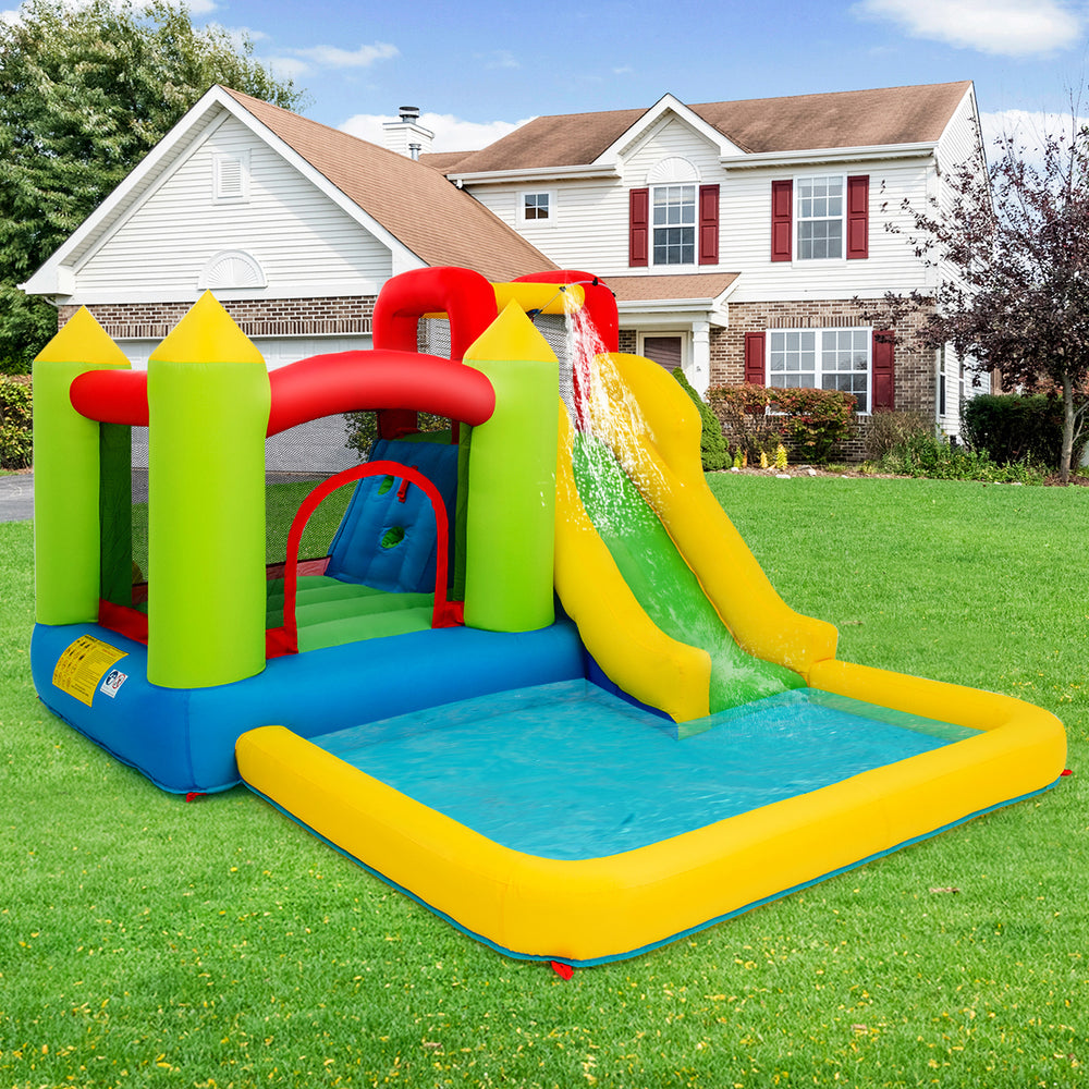 Brightly colored outdoor inflatable bounce house with slide and water spray feature, perfect for gardens and lawns.