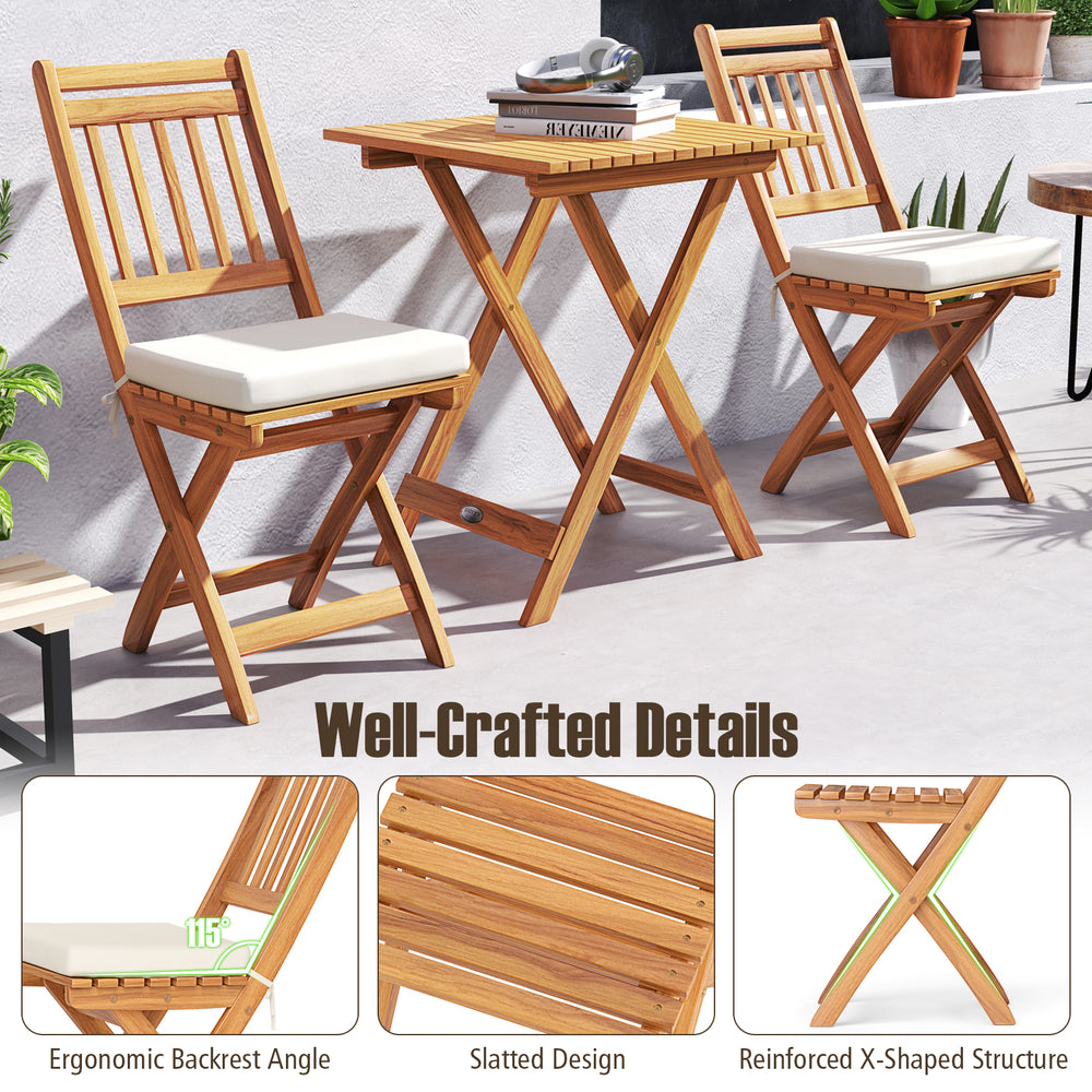 Outdoor wood bistro set featuring two chairs with soft cushions and a folding table, perfect for backyard relaxation.