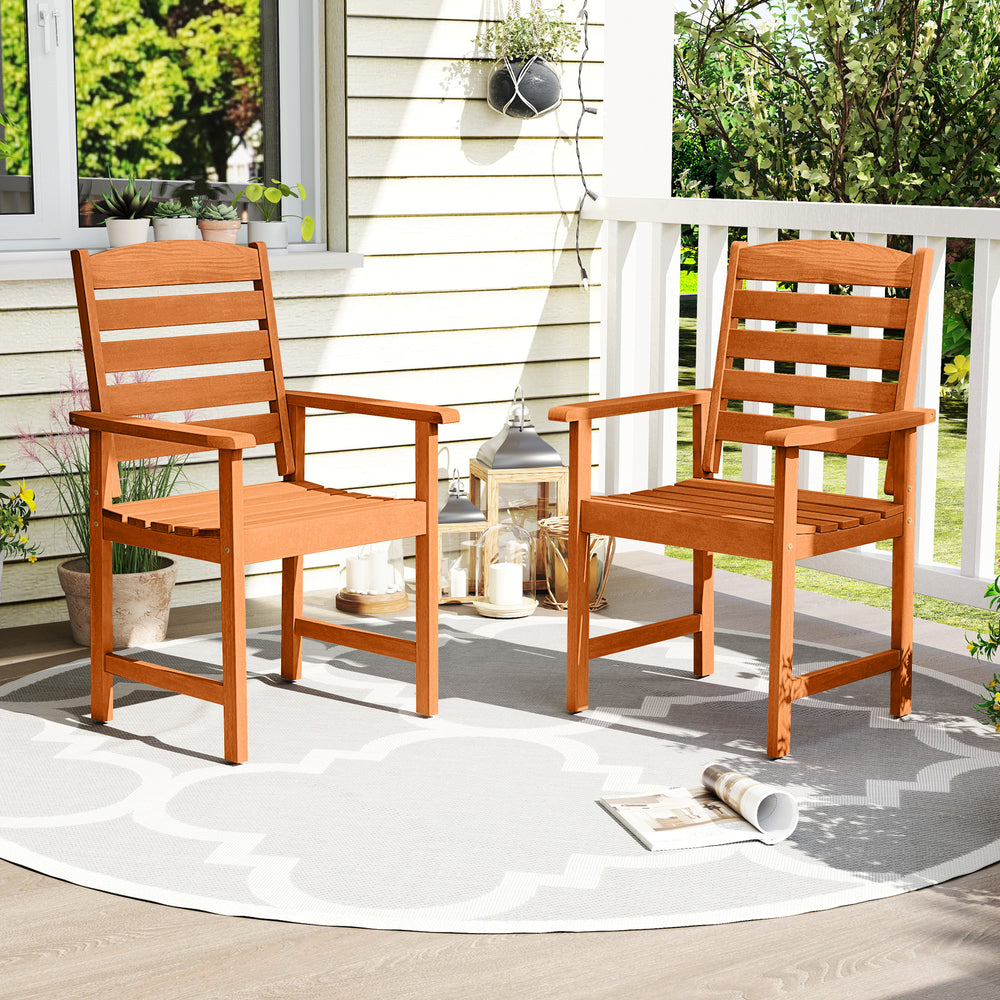 Side view of an outdoor wooden dining chair with slatted seat and cozy armrests, ideal for comfortable patio seating.