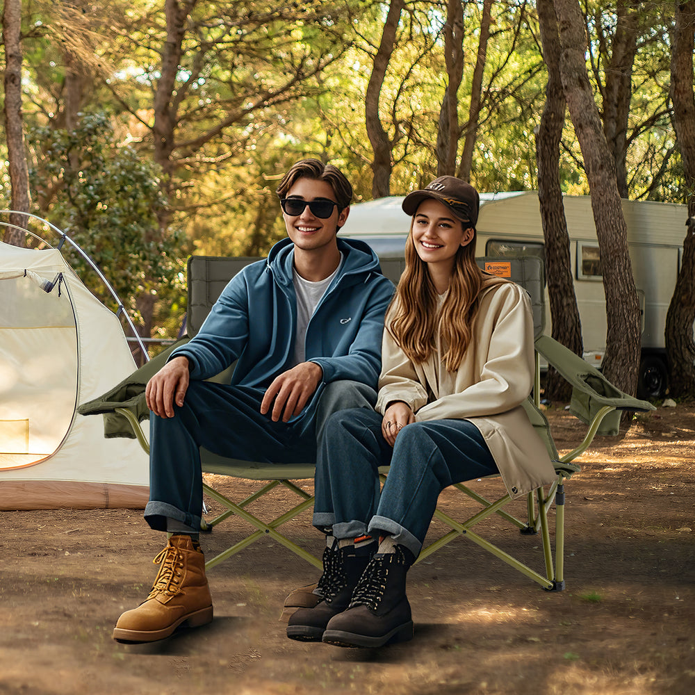 Oversized green camping loveseat with cup holders, thick padding, and adjustable armrests for ultimate comfort outdoors.