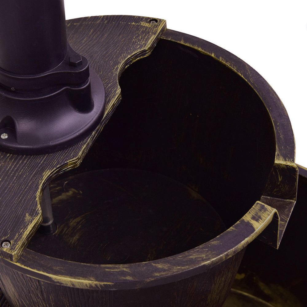 Close-up of the 2-tier outdoor barrel waterfall fountain showing the pump and water reservoir for garden ambiance.