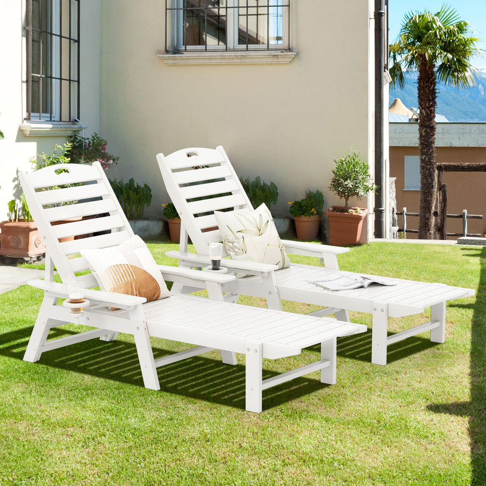 White patio chaise lounge chairs with adjustable backrests, perfect for poolside or backyard relaxation.