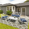 4-piece outdoor conversation set featuring a sturdy steel frame, thick cushions, and a side table for patio relaxation.