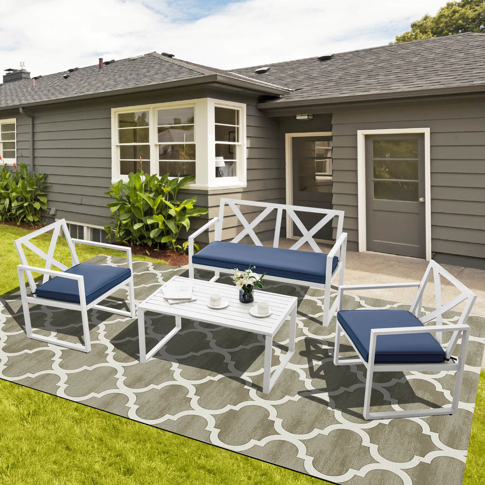 4-piece outdoor conversation set featuring a sturdy steel frame, thick cushions, and a side table for patio relaxation.