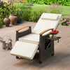 Patio wicker recliner chair with adjustable backrest and footrest, featuring a white cushion and side table for outdoor.