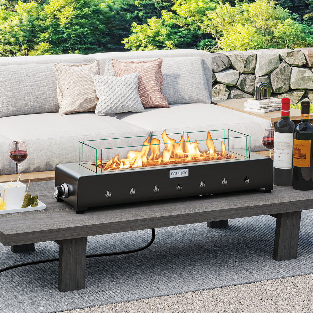 Portable mini fireplace with stainless steel burner and wind guard, perfect for outdoor table settings.