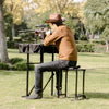 Foldable shooting bench with adjustable height, featuring a durable steel frame and large 24" x 24" shooting platform.