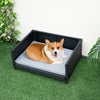 Rattan dog bed with waterproof cushion for medium small pets, featuring a sturdy design and elevated bottom for comfort.