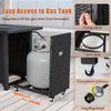 Gas tank storage with easy access and casters for the 50000 BTU propane fire pit table in black rattan design.