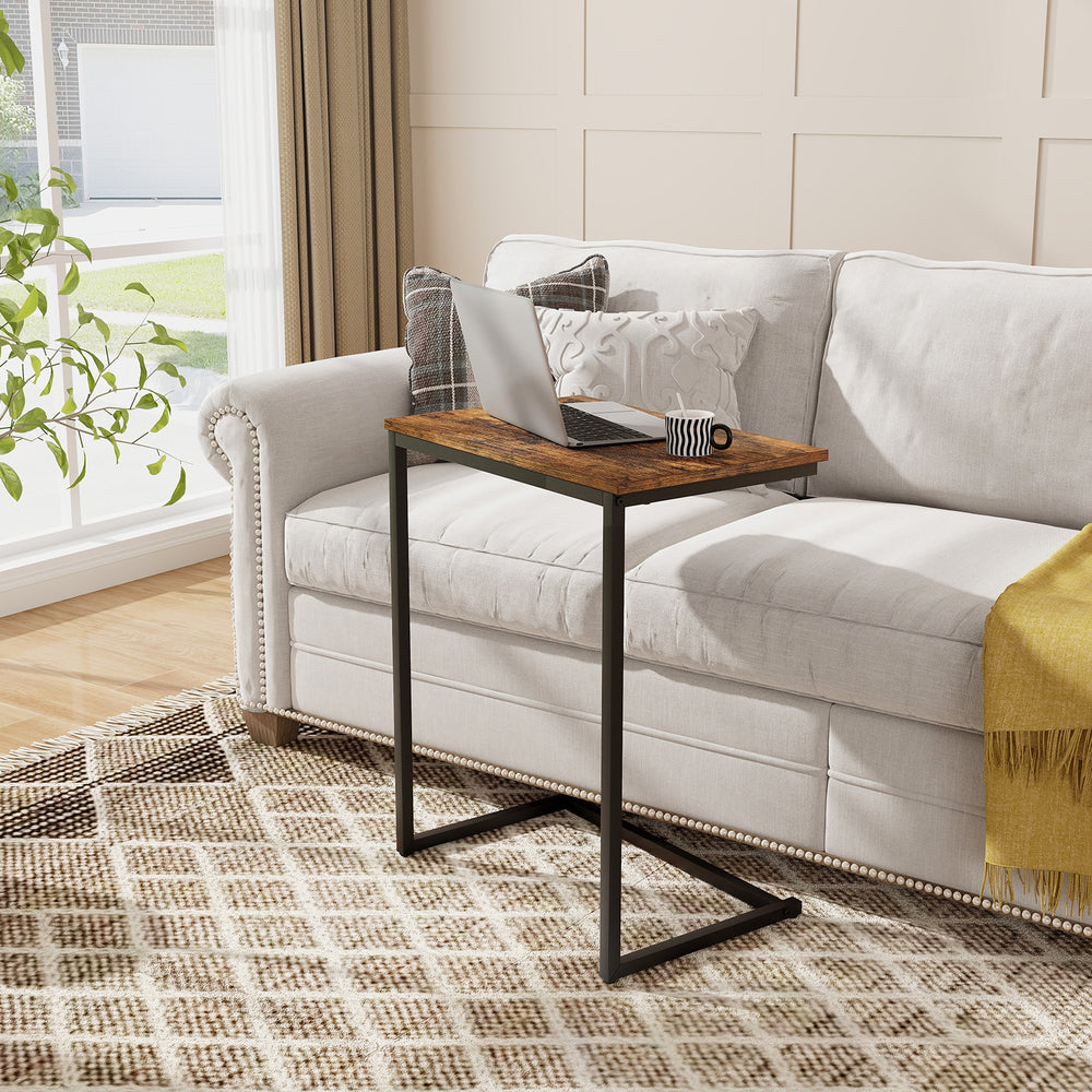 C-shaped industrial end table featuring a spacious tabletop, ideal for work or snacks, fitting snugly beside a sofa.
