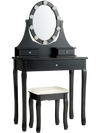 Elegant black vanity dressing table with a decorative oval mirror, three drawers, and a cushioned stool for comfortable.