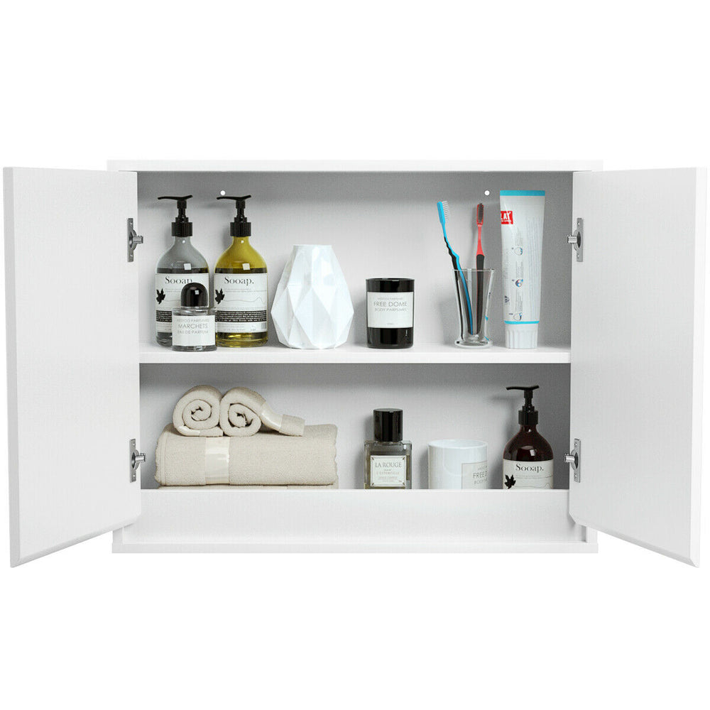 Wall-mounted mirrored medicine cabinet with open doors showcasing organized toiletries and towels for bathroom storage.