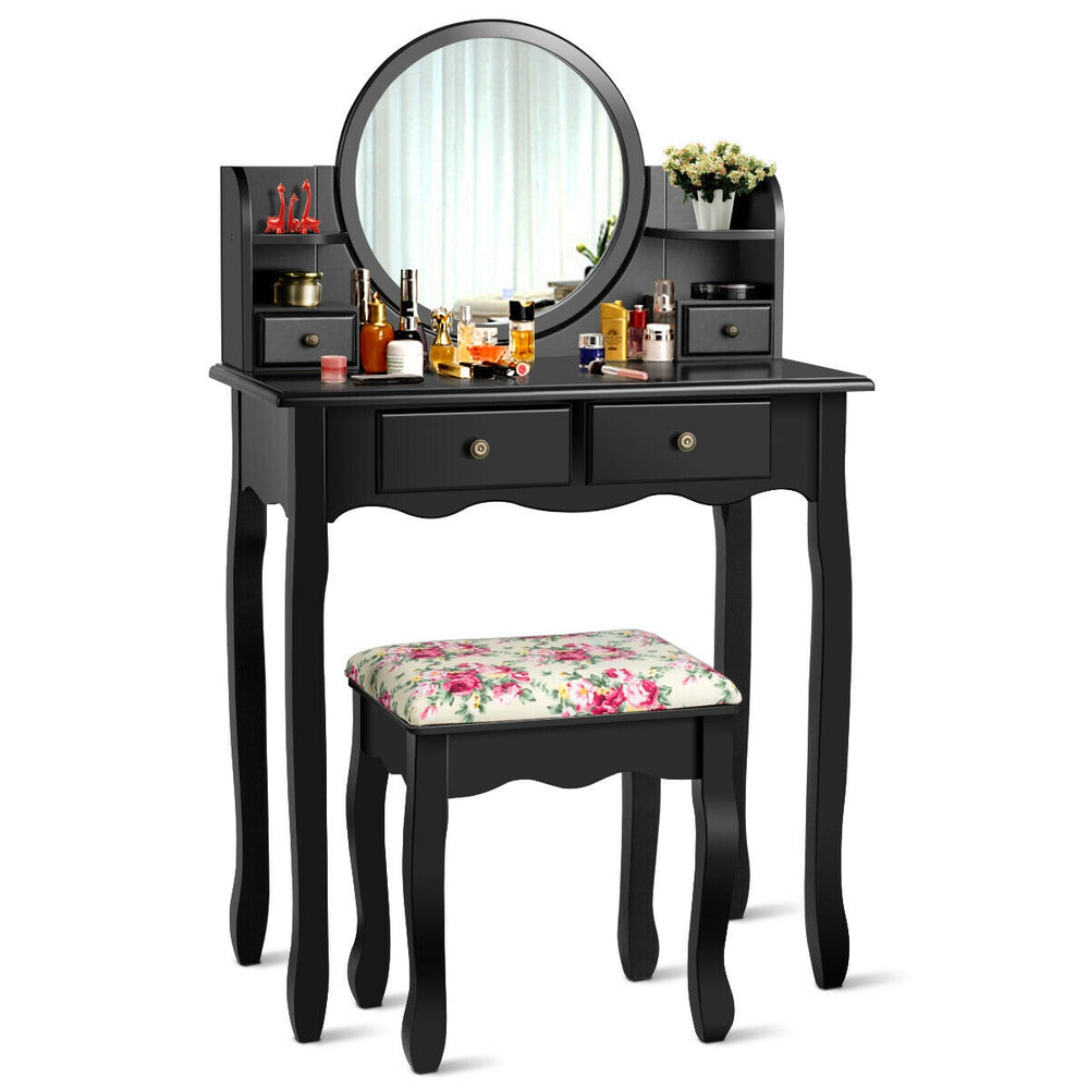 Black makeup vanity table set with oval mirror, 4 drawers, and cushioned stool for comfortable dressing experience.