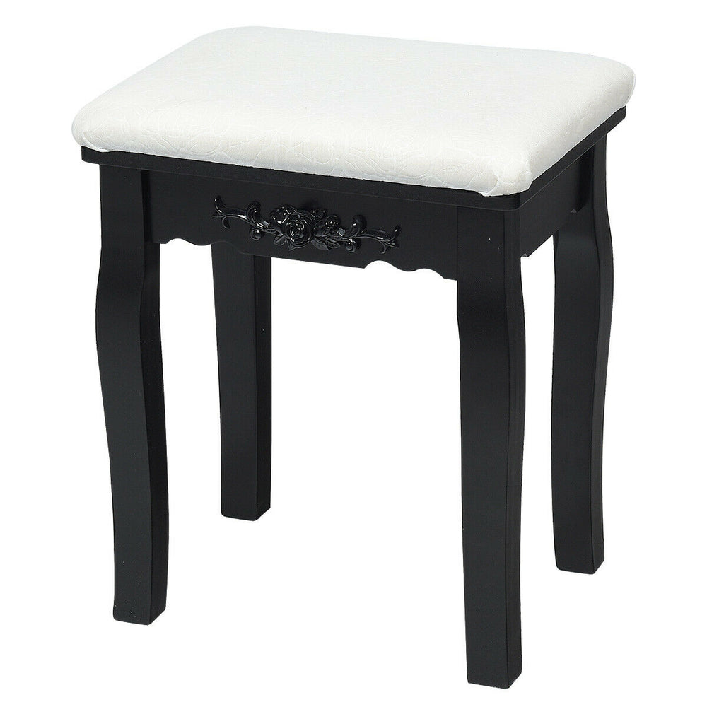 Cushioned stool with black frame, part of a vanity table set, perfect for bedroom or small spaces.