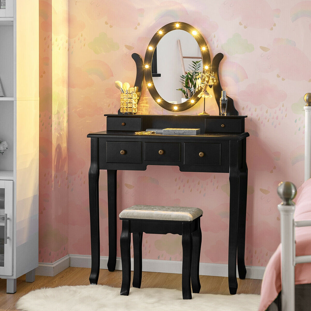 Black vanity table set with 5 drawers, oval mirror, and 12 LED bulbs, perfect for makeup and writing in any room.