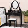 Elegant black vanity table set with lighted mirror, cushioned stool, and five drawers for ample storage in any space.