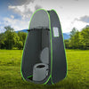 Portable travel toilet in a compact pop-up tent, designed for outdoor use, featuring a removable inner bucket and paper.