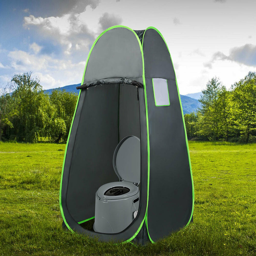 Portable travel toilet in a compact pop-up tent, designed for outdoor use, featuring a removable inner bucket and paper.