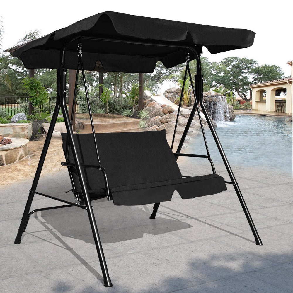 Black loveseat cushioned patio swing glider with waterproof canopy, perfect for outdoor relaxation by the pool.