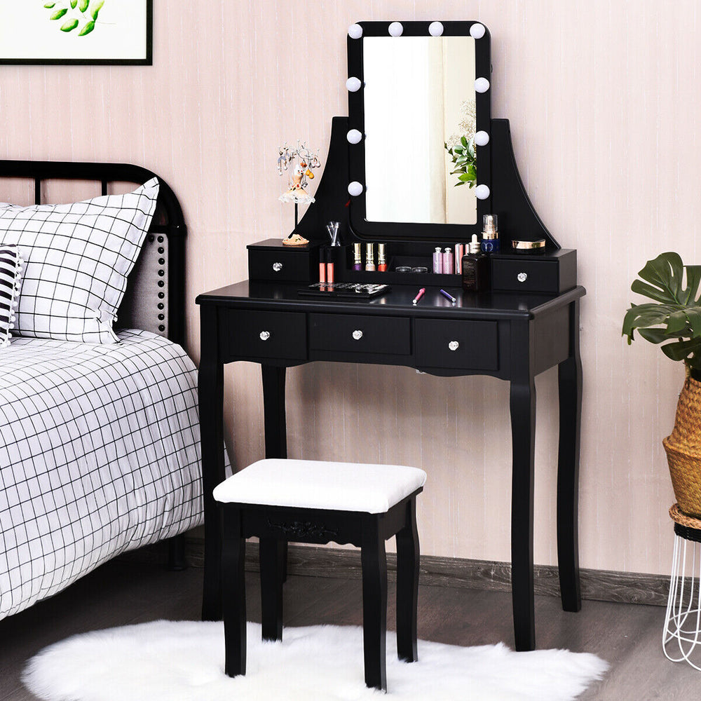 Close-up of the black vanity dressing table's 360° mirror and crystal drawer handles, showcasing elegant design and.