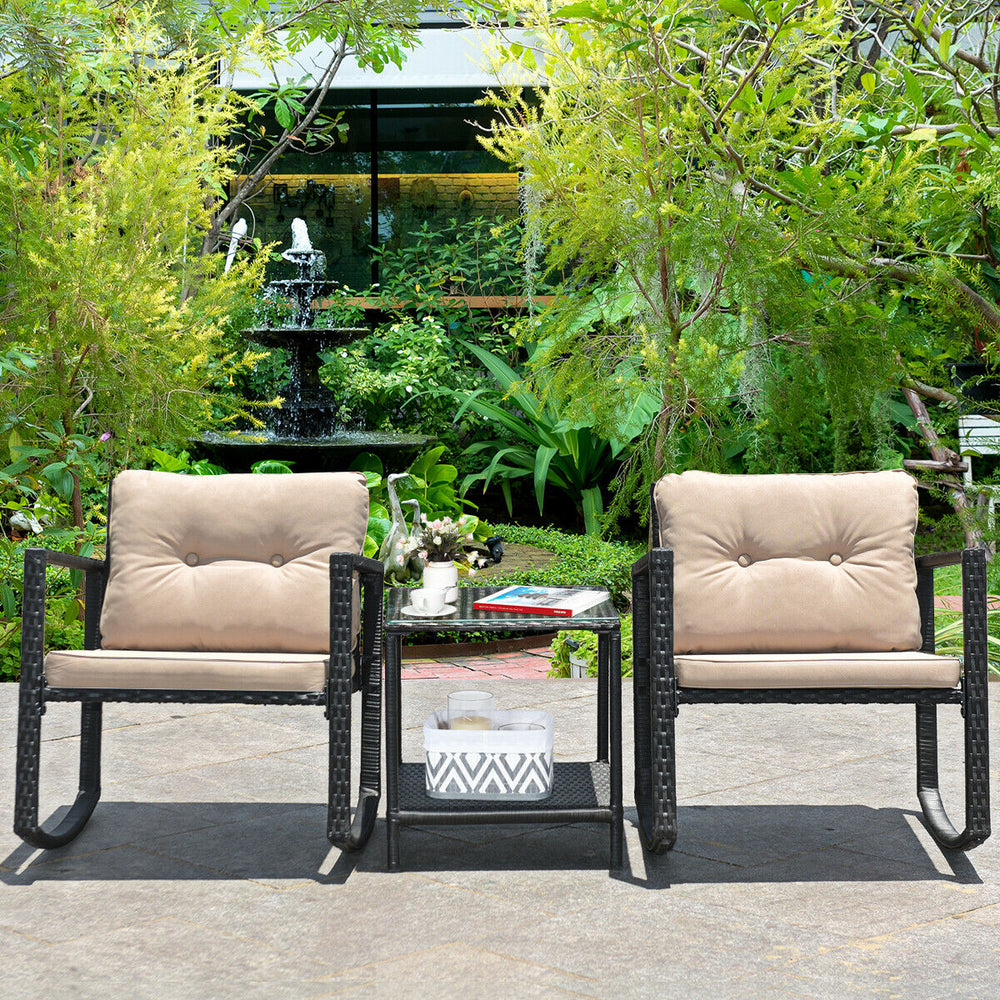 Two beige rocking chairs with soft cushions and a glass coffee table in a lush garden setting, perfect for outdoor.