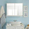 Wall-mounted 2-door mirrored medicine cabinet in a bathroom setting, featuring elegant design and space-saving storage.