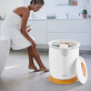 Bathroom towel warmer bucket in white with fragrance holder, ideal for warming towels and pajamas, shown in a modern.
