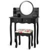 Black makeup vanity table set with oval mirror, 4 drawers, and cushioned stool, perfect for girls' dressing needs.