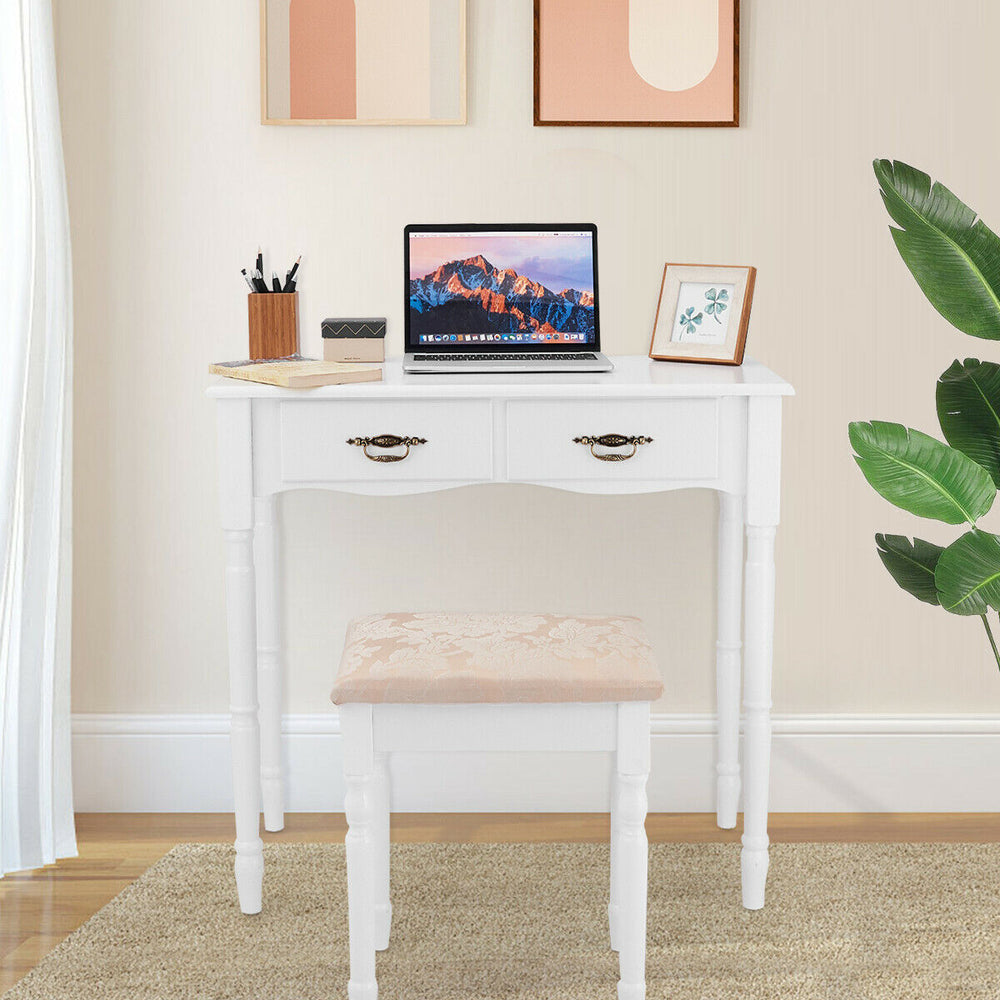 White vanity set with tri-fold mirror, cushioned stool, and four storage drawers for makeup organization.
