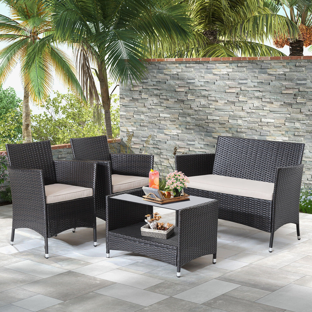 4-piece patio conversation set featuring a loveseat, two armchairs, and a coffee table with tempered glass, ideal for.